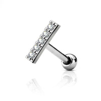 Zilverkleurige barbell piercing van chirurgisch staal met brass afwerking en bar met zirconia. Geschikt voor oorpiercings met minimalistisch design en subtiele glans.